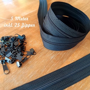 Pode incluir: Um rolo de fita de zíper preta com 25 puxadores. A fita tem 5 metros de comprimento. Os puxadores são de metal preto.