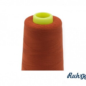 Può includere: Un'bobina di filo arancione con un'bobina di plastica gialla.