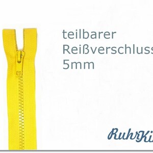 Könnte beinhalten: Ein gelber 5mm Reißverschluss mit einem Metall-Schieber. Der Reißverschluss ist mit "teilbarer Reißverschluss 5mm" und "RuhrKind" beschriftet.