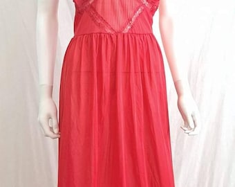 May include: A red, sheer, long nightgown with a ruffled neckline and lace trim. The gown has a fitted bodice and a flowing skirt.