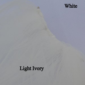 May include: Close-up of two swatches of fabric, one white and one light ivory. The swatches are labeled "White" and "Light Ivory".