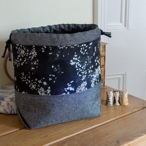 Drawstring project bag made with elegant monochrome fabrics in glamorous shades of black, cream and silver