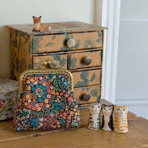 Coin purse made with Liberty Tana Lawn in the print: 'Little Marquess', a bronze and gold lining, and hand stitched bronze metal frame