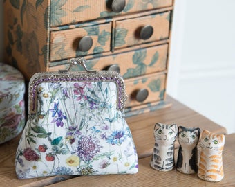 Coin purse made with wild flower print Liberty Tana Lawn outer, purple cotton interior, and a hand stitched silver colour metal frame