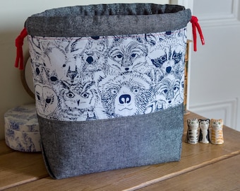 Drawstring project bag made with lovely cotton print featuring woodland animals in crisp black and white, with a red lining