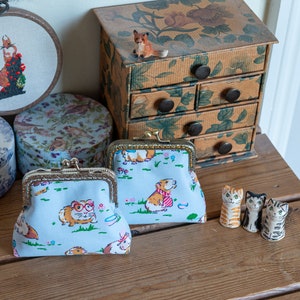 Coin purse made with very cute Guinea Pig print and a choice of 2 metallic Essex Linen linings, with a hand stitched metal frame