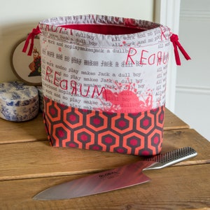 Drawstring project bag made with fabric inspired by The Shining, with a blood red lining and drawstrings! Perfect for smaller projects
