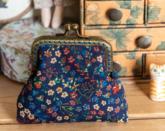 Coin purse made with Liberty Tana Lawn in the print: 'Donna Leigh', a blue cotton lining, and hand stitched bronze coloured metal frame