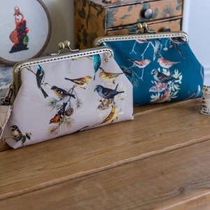 Wristlet purse or small clutch made with pretty digital printed bird themed cotton lawn, and lined with metallic Essex Linen
