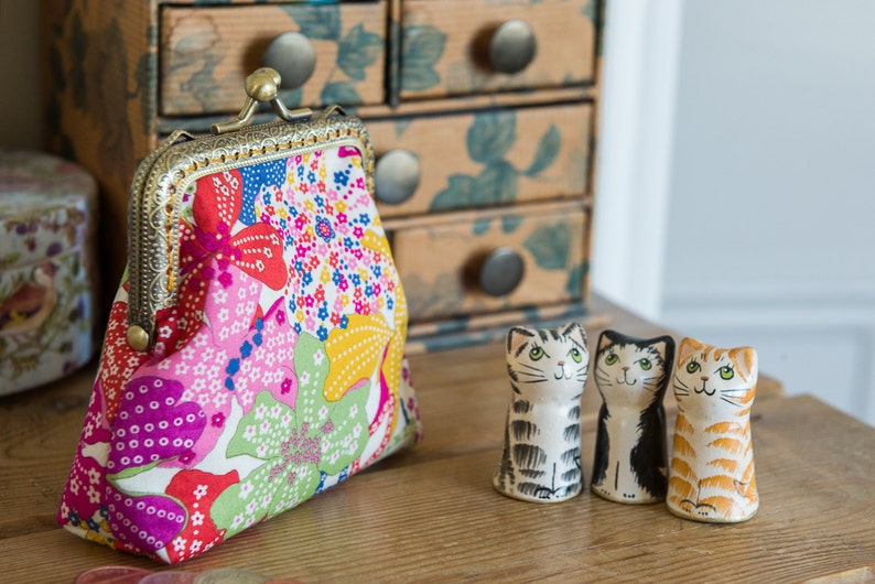 Coin purse made with Mauvey print Liberty Tana Lawn, a golden lining, and a hand stitched bronze colour metal frame image 2