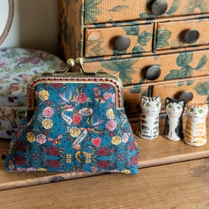 Coin purse made with beautiful vintage classic tattoo cotton print lined with a gold metallic red Essex linen and hand stitched frame