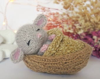 Tiny knit mouse sleeping in walnut shell basket