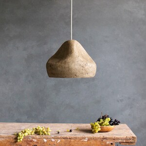 Paper Mache green Light Sculpture Sensi in the dining room