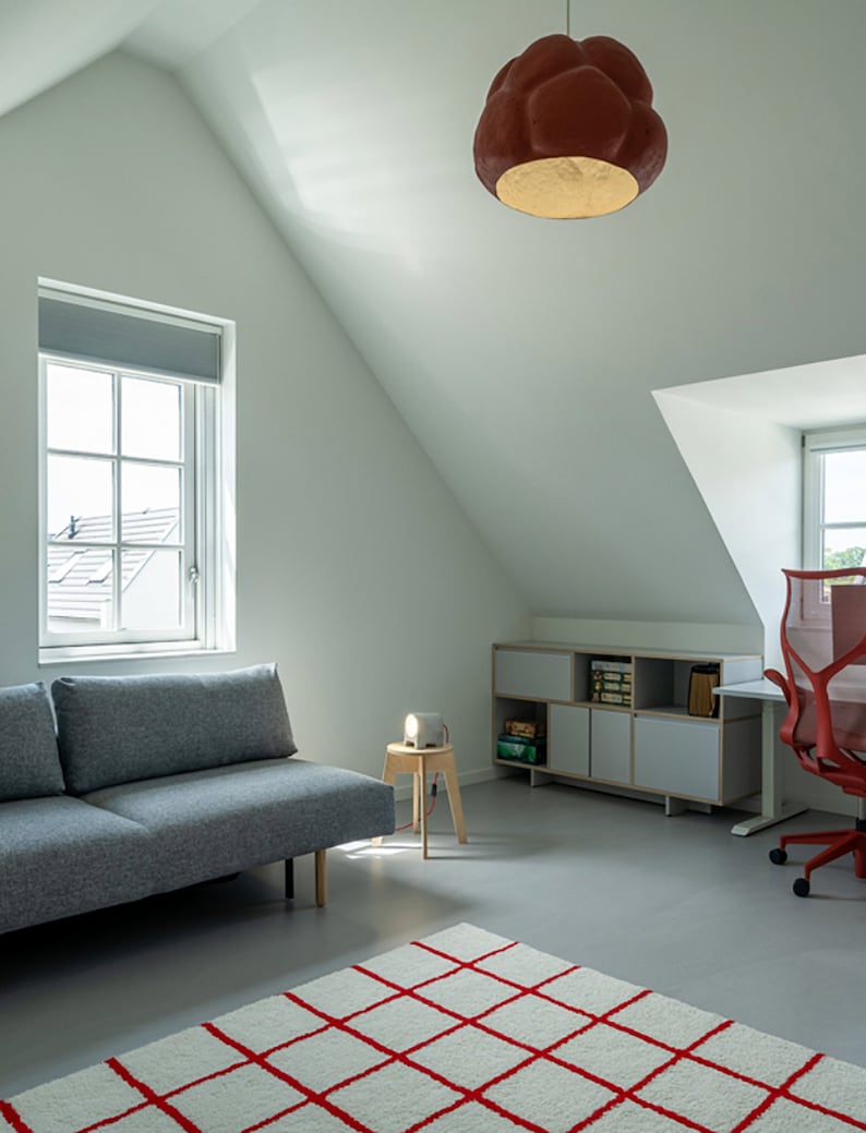 sculptural red Pendant Light made from Paper Mache called Sensi in the living room