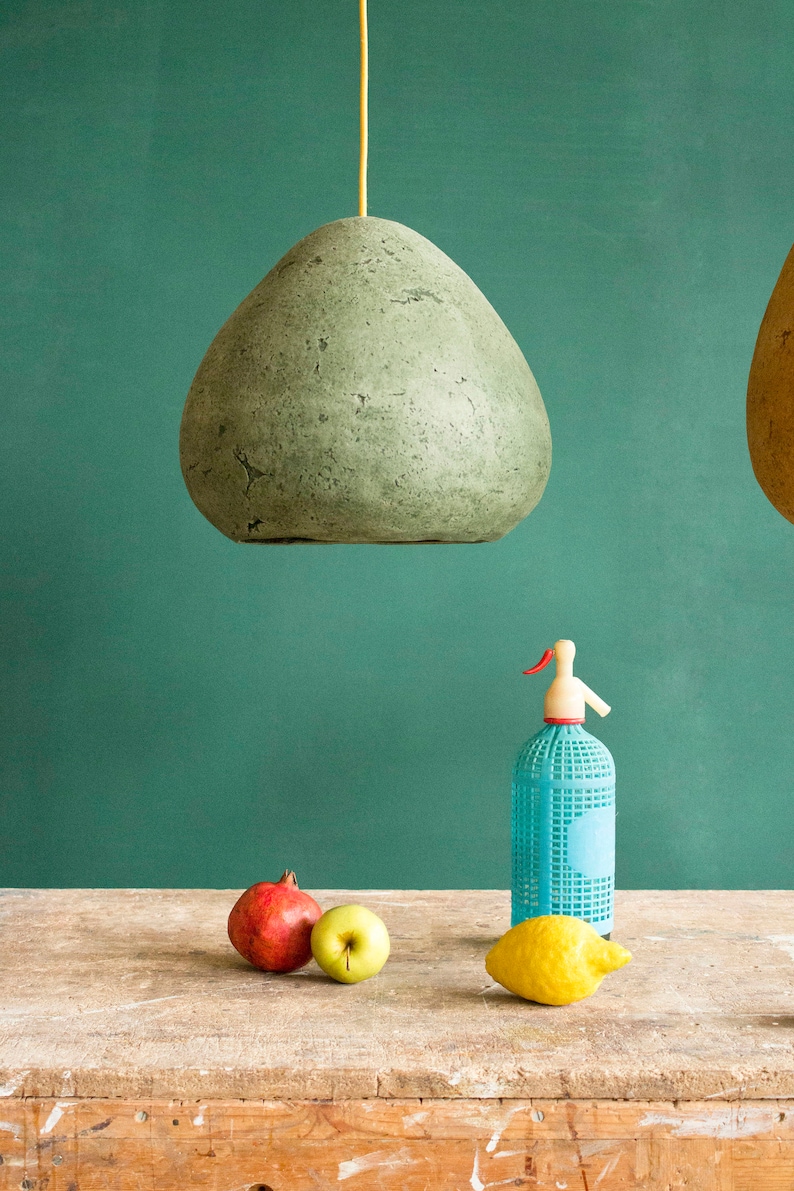 Modern green Pendant Light made of paper mache above the kitchen table