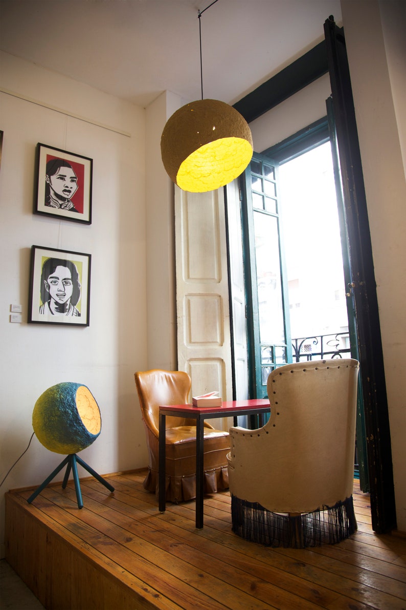 big orange Pendant light Jupiter made of paper mache in the restaurant