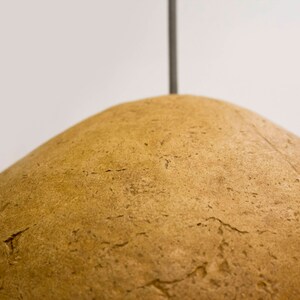 detail of Minimalist yellow Lamp for Kitchen Island made of paper mache