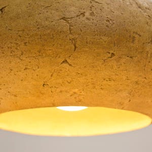 detail of Minimalist yellow Lamp for Kitchen Island made of paper mache