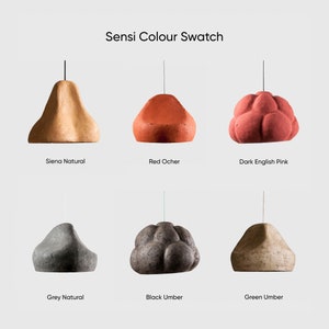 May include: A color swatch of six ceramic pendant lights in various colors, including sienna natural, red ocher, dark english pink, grey natural, black umber, and green umber. The lights are all in the shape of a pear or a cloud.