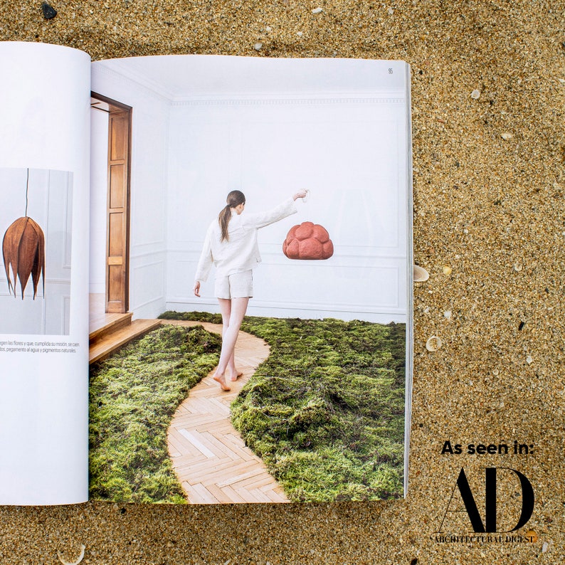 sculptural red Pendant Light made from Paper Mache called Sensi in Architectural digest newspaper