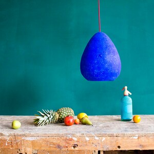 Modern Ceiling Light Made from Paper Mache in ultramarine blue colour above the kitchen table