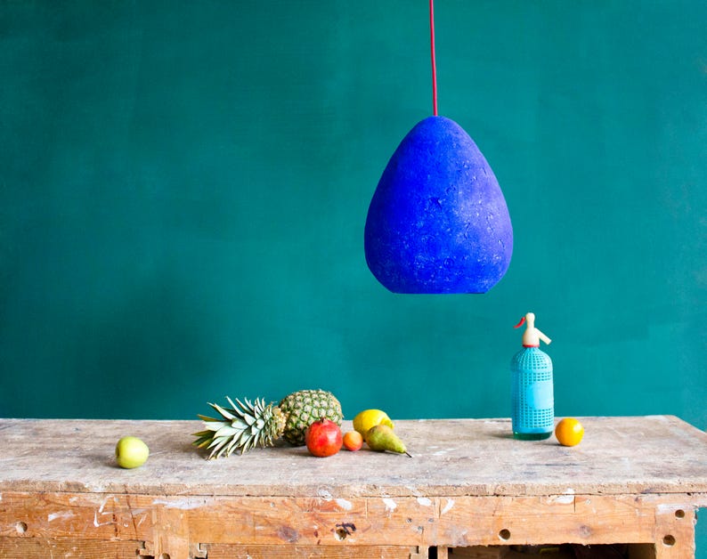 Modern Ceiling Light Made from Paper Mache in ultramarine blue colour above the kitchen table