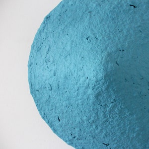 detail of Rustic Sconce Lamp made from Paper Mache in blue colour