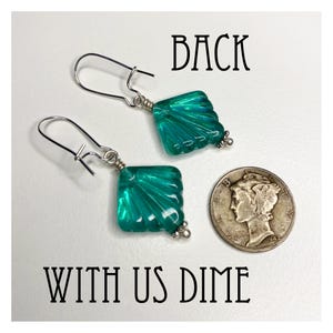 May include: A pair of silver earrings with teal blue glass square-shaped dangles. The dangles have a fan-like design. The earrings are shown with a US dime for size comparison.  BACK WITH US DIME