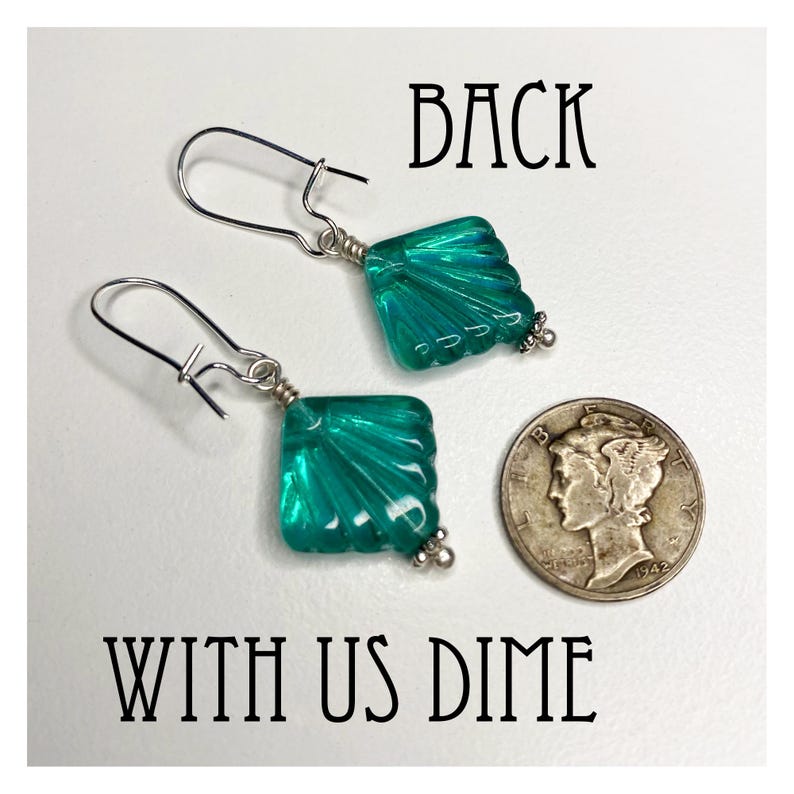 May include: A pair of silver earrings with teal blue glass square-shaped dangles. The dangles have a fan-like design. The earrings are shown with a US dime for size comparison.  BACK WITH US DIME