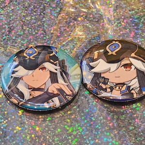 May include: Two round, colorful buttons featuring anime-style character illustrations. One button has a teal background, while the other has a brown background. Both buttons have the same character with white hair, red eyes, and a detailed outfit.