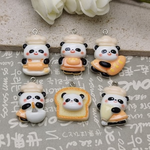 May include: Six ceramic panda bear charms with silver jump rings. The pandas are wearing chef hats and holding various baking items, including a rolling pin, a whisk, a loaf of bread, and a pastry bag.