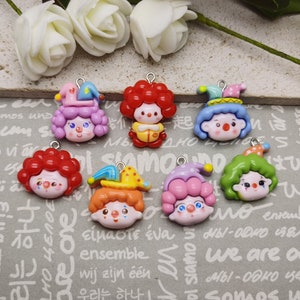 May include: Assortment of colorful clown charm pendants with different hair colors and facial expressions. The charms are made of plastic and have a shiny finish.