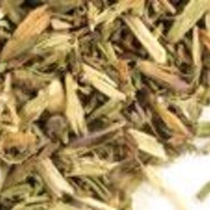 May include: A collection of dried thyme leaves and stems, featuring a mix of earthy green, brown, and tan tones. The texture is coarse and fragmented, consisting of small, brittle herbal pieces scattered together in a dense, irregular pile.