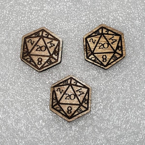 May include: Three wooden 20-sided dice with black numbers. The dice are shaped like a dodecahedron and have the numbers 2, 4, 6, 8, 10, 12, 14, 16, 18, 20 on the faces.