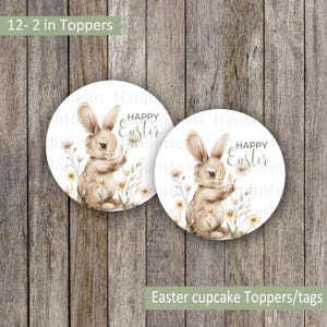 May include: Twelve 2-inch round cupcake toppers featuring a watercolor illustration of a brown bunny holding a flower with the text "Happy Easter" in green and white lettering.