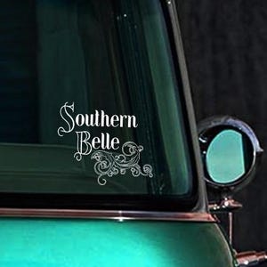 May include: A teal green car with a white vinyl decal that says "Southern Belle" with a floral design.