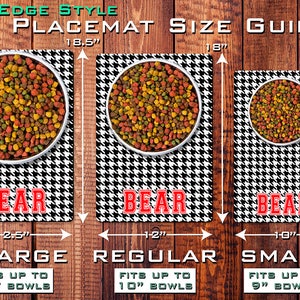 May include: Three black and white houndstooth pet placemats with red "BEAR" text. The placemats are shown with bowls of pet food and measurements for different sizes: 18.5 inches (XL), 18 inches (Regular), and 16 inches (Small).