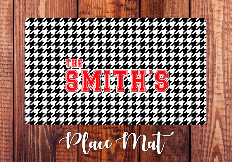 May include: Black and white houndstooth place mat with the text "THE SMITH'S" in red.