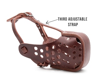 May include: Brown leather dog muzzle with a third adjustable strap. The muzzle has a perforated design and is secured with a buckle.