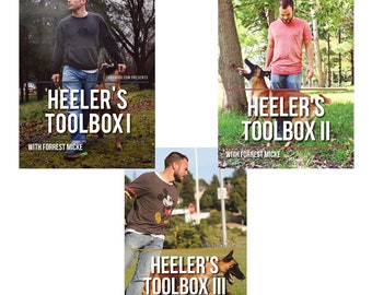 May include: Three book covers with a blue and white color scheme. Each cover features a man and a dog. The text on the covers reads "Heeler's Toolbox I", "Heeler's Toolbox II", and "Heeler's Toolbox III".