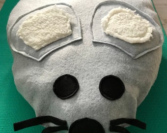 May include: A gray plush mouse pillow with black felt eyes, nose, and whiskers. The pillow has a white fluffy patch on each side of the head.