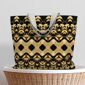 May include: A black and gold tote bag with a geometric pattern. The bag has a white canvas strap.