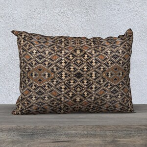 May include: A decorative throw pillow with a geometric pattern in shades of brown, black, and beige. The pillow has a diamond-shaped design with a subtle sheen.