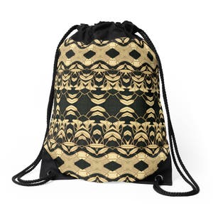 May include: Black drawstring backpack with a repeating geometric pattern in gold and tan. The pattern is set against a dark background. The bag has black drawstrings and a black base.
