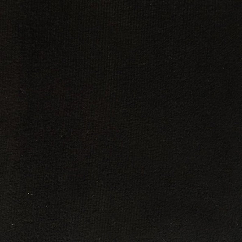 May include: A black fabric with a soft, fuzzy texture.