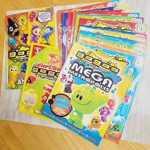 Può includere: Una collezione di riviste e libretti Gogo's Crazy Bones con illustrazioni di personaggi colorati, fumetti e curiosità. Le copertine mostrano varie piccole figure in plastica, una tipografia audace e sfondi grafici gialli, blu e rossi brillanti.