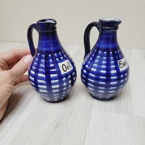 May include: A set of three ceramic mugs with a speckled, matte finish. The mugs are in shades of cream, light gray, and dark gray. Each mug has a simple, minimalist design and a rounded handle. Perfect for coffee or tea.