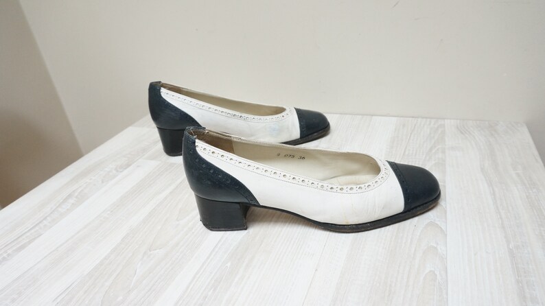 black and white spectator flats