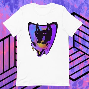 May include: White t-shirt featuring a cartoon wolf head with a purple, blue, and yellow gradient design. The wolf is black with yellow eyes and a pink tongue. The graphic is set within a purple shield shape.