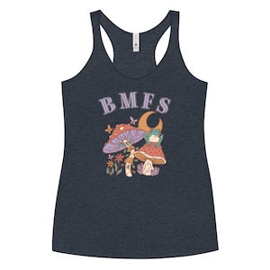May include: Dark navy blue tank top with a whimsical graphic featuring mushrooms, a frog on a crescent moon, and the letters "BMFS" in lavender. The design includes butterflies and flowers.